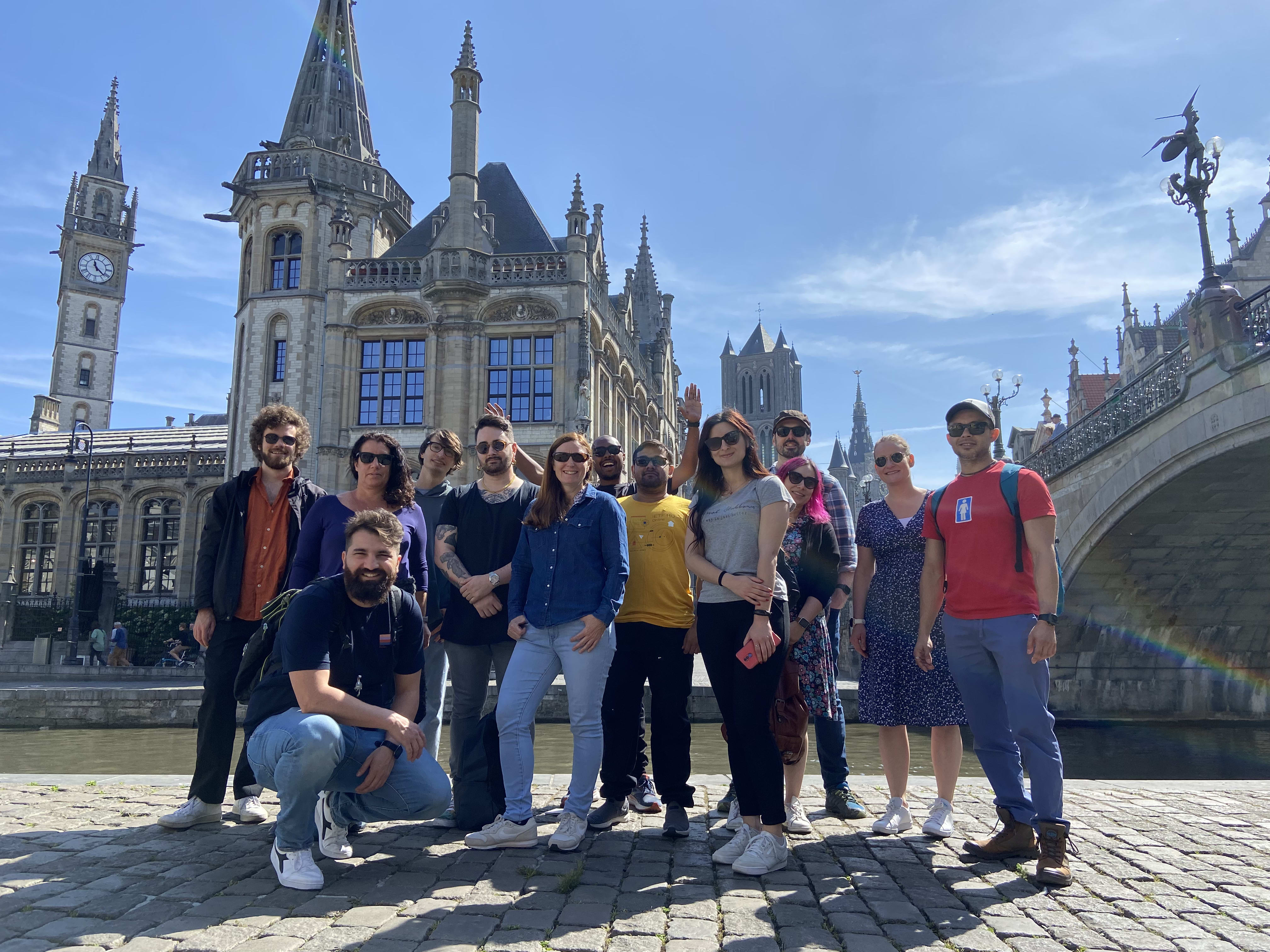 group of speakers in front of beautiful buildings in the city of Ghent