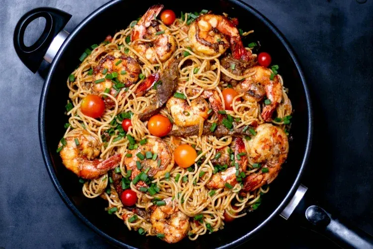 seafood pasta in a black pan