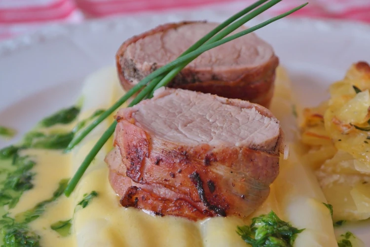 Porcloin with a side of potato gratin on a plate