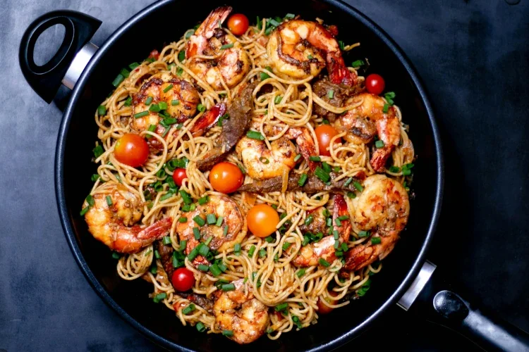 seafood pasta in a black pan