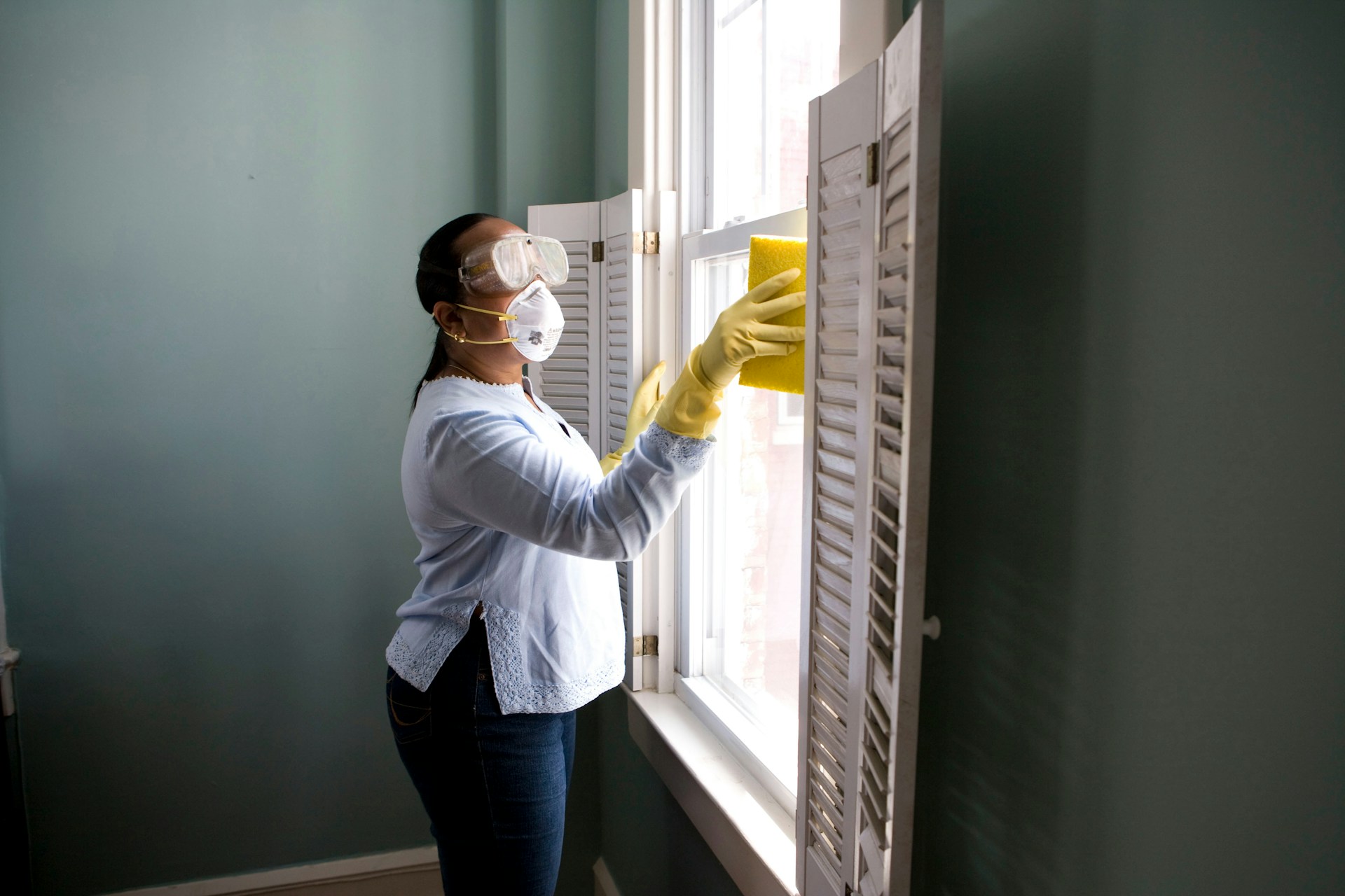 Professional cleaner deep cleaning a residential home