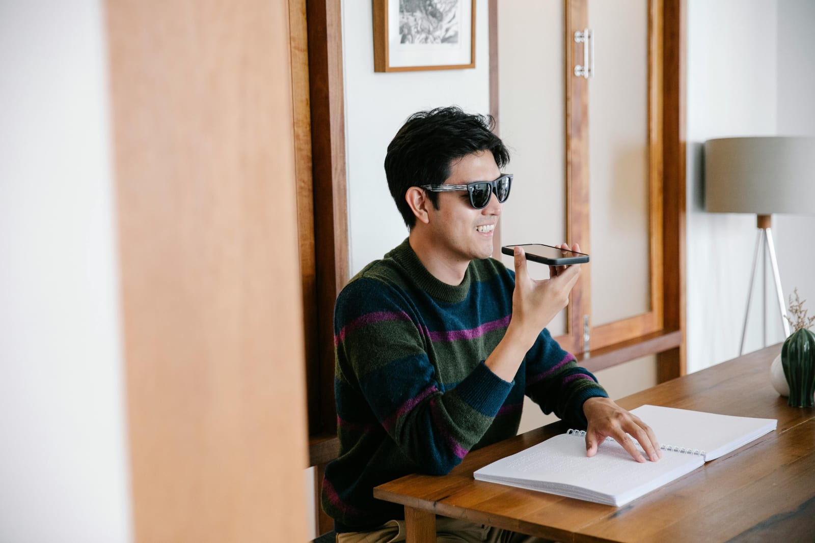 Man happily talking on phone while working