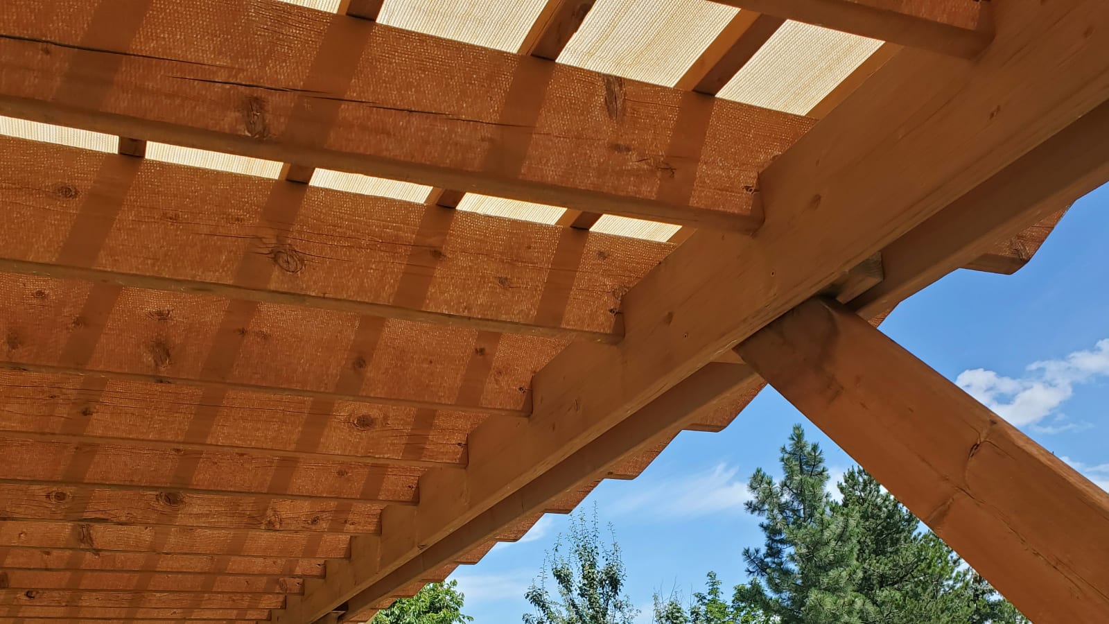 The underside of a well-crafted pergola, built with precision by NIB in Spokane, WA. This functional outdoor space provides the perfect combination of shade and openness, offering a peaceful retreat. The beams and cross supports are designed not only for structural integrity but also for aesthetic appeal. NIB’s attention to detail ensures that every angle and joint is thoughtfully placed, creating a relaxing outdoor area that enhances the beauty and functionality of any home.