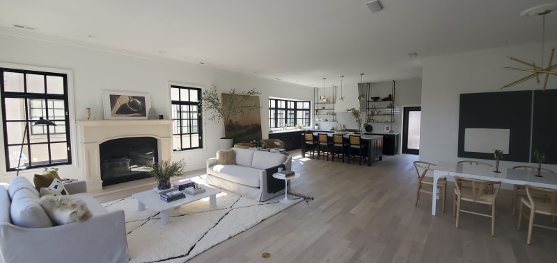 This inviting bedroom features custom paneling on the accent wall installed by NIB in Spokane, WA. The neutral tones of the paint and the luxurious textures of the bedding and pillows create a serene and restful atmosphere. The design, complemented by elegant nightstands and soft lighting, transforms the space into a comfortable retreat, balancing both style and function. The subtle details, like the clean lines of the paneling and the warm wood flooring, provide a perfect backdrop for relaxation.