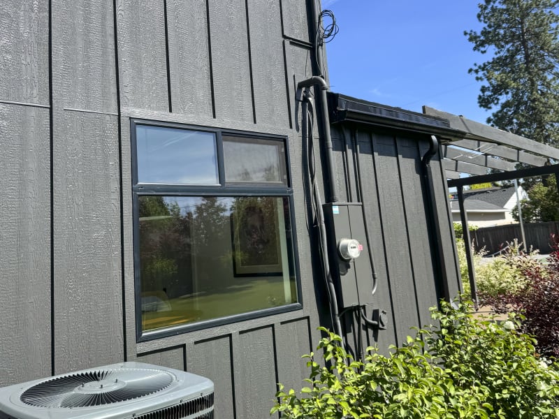 The beautifully installed siding is complemented by the sleek, modern windows that enhance the home's exterior in Spokane, WA. The distinct lines of the siding, paired with the architectural details like the utility box and air conditioning unit, show the precision and attention to detail NIB applies in every project. This combination of function and design is a perfect example of NIB's ability to blend practicality with aesthetic appeal, transforming any home’s exterior into a stylish and durable space.