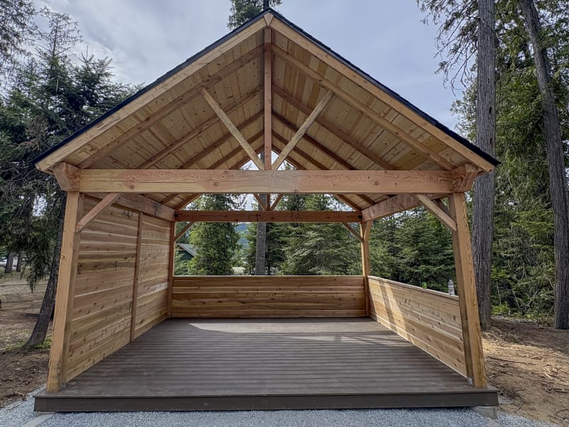 A custom-built outdoor structure with a wooden frame and roof, designed as a functional space. This project, completed by NIB in Spokane, WA, showcases their expertise in creating durable and attractive outdoor living areas.