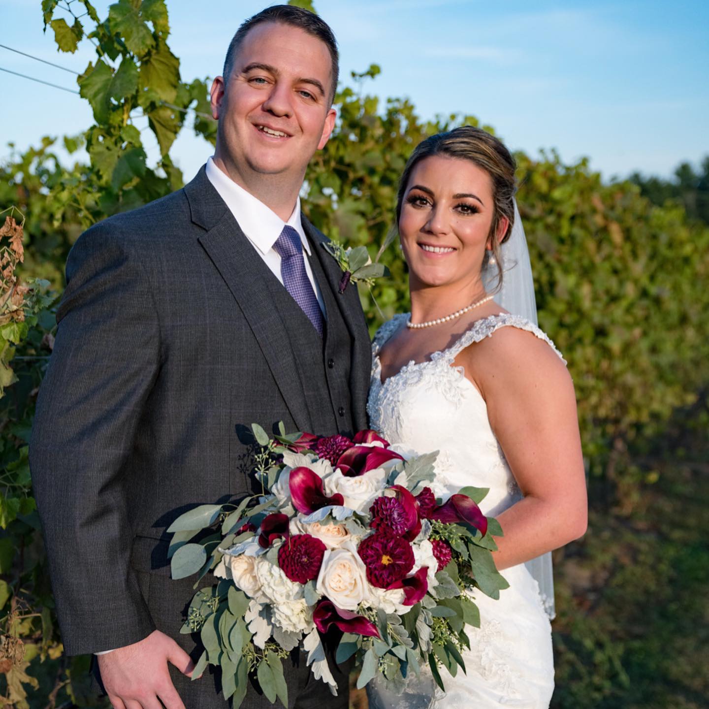 Bride and groom with custom wedding bouquet by Designs By Don Florist in Wilmington MA
