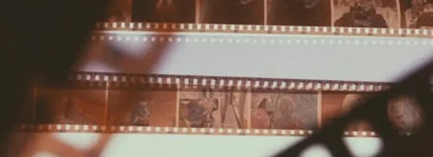 Close-up of 35mm film strip showing the silver halide emulsion and sprocket holes