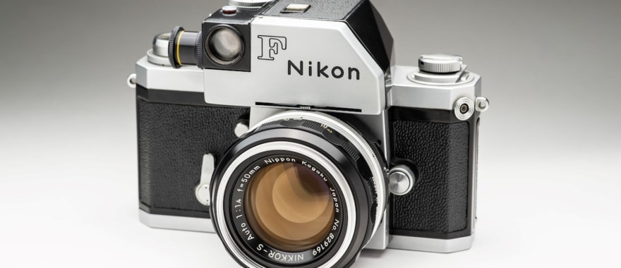 A Nikon F camera from 1959, or a photojournalist working with a 35mm SLR in the field