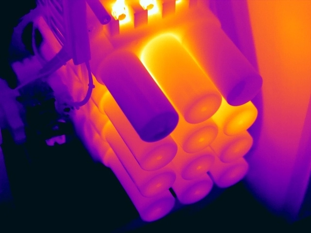 Thermal image showing two outer capacitors operating cooler than comparable capacitors in the bank, indicating possible dielectric failure