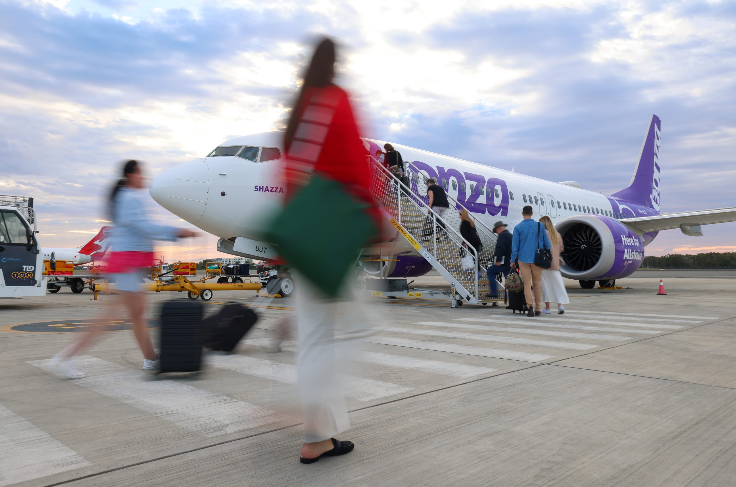 Blurred image of woman walking to Bonza aircraft