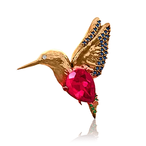Broche de colibrí de lujo en oro con gema roja y detalles en zafiro azul