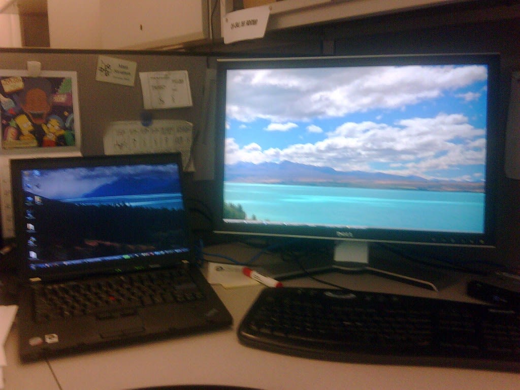 displayfusion The image is blurry, thanks to my BlackBerry camera, but you can clearly see how the wallpaper is between both displays