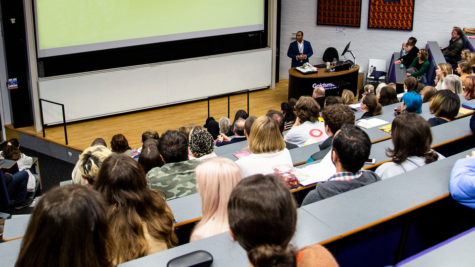 A lecturer at the front of a classroom