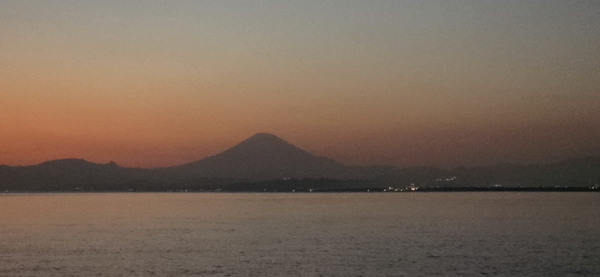 Mount Fuji silhouette across Sagami Bay at sunset, seen from the Sea Candle deck