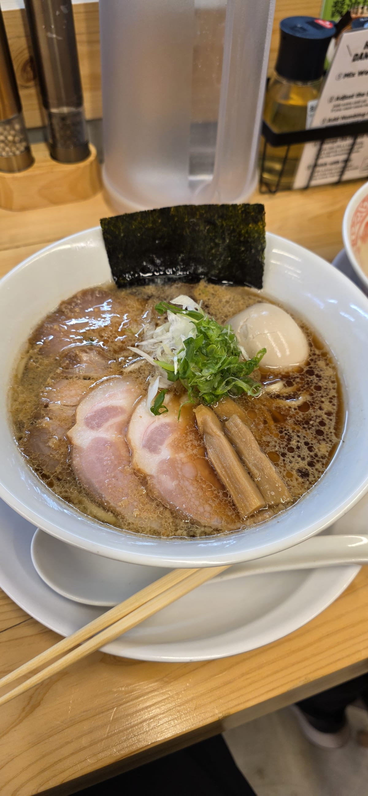 A bowl of Japanese ramen with chashu pork, soft-boiled egg, and noodles