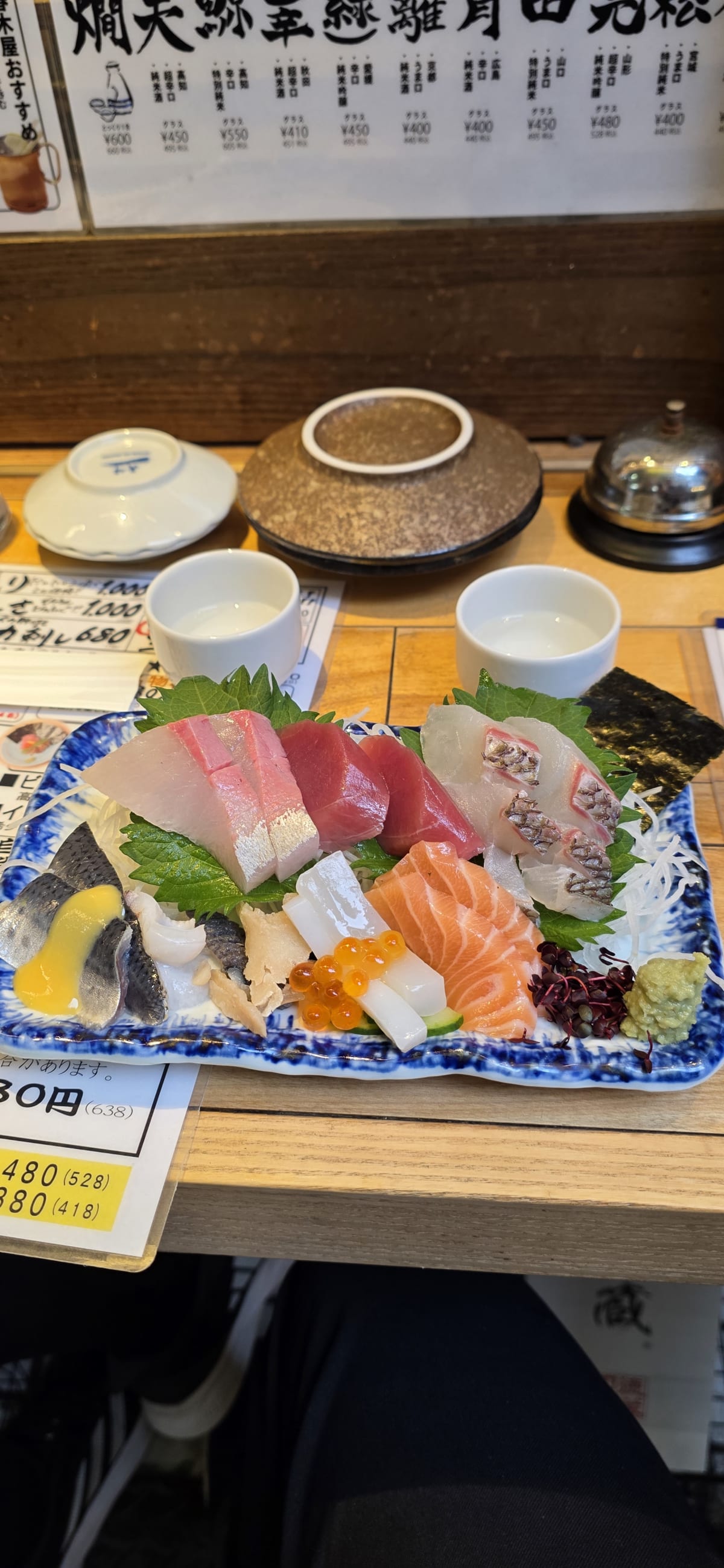 An assortment of nigiri sushi on a wooden board