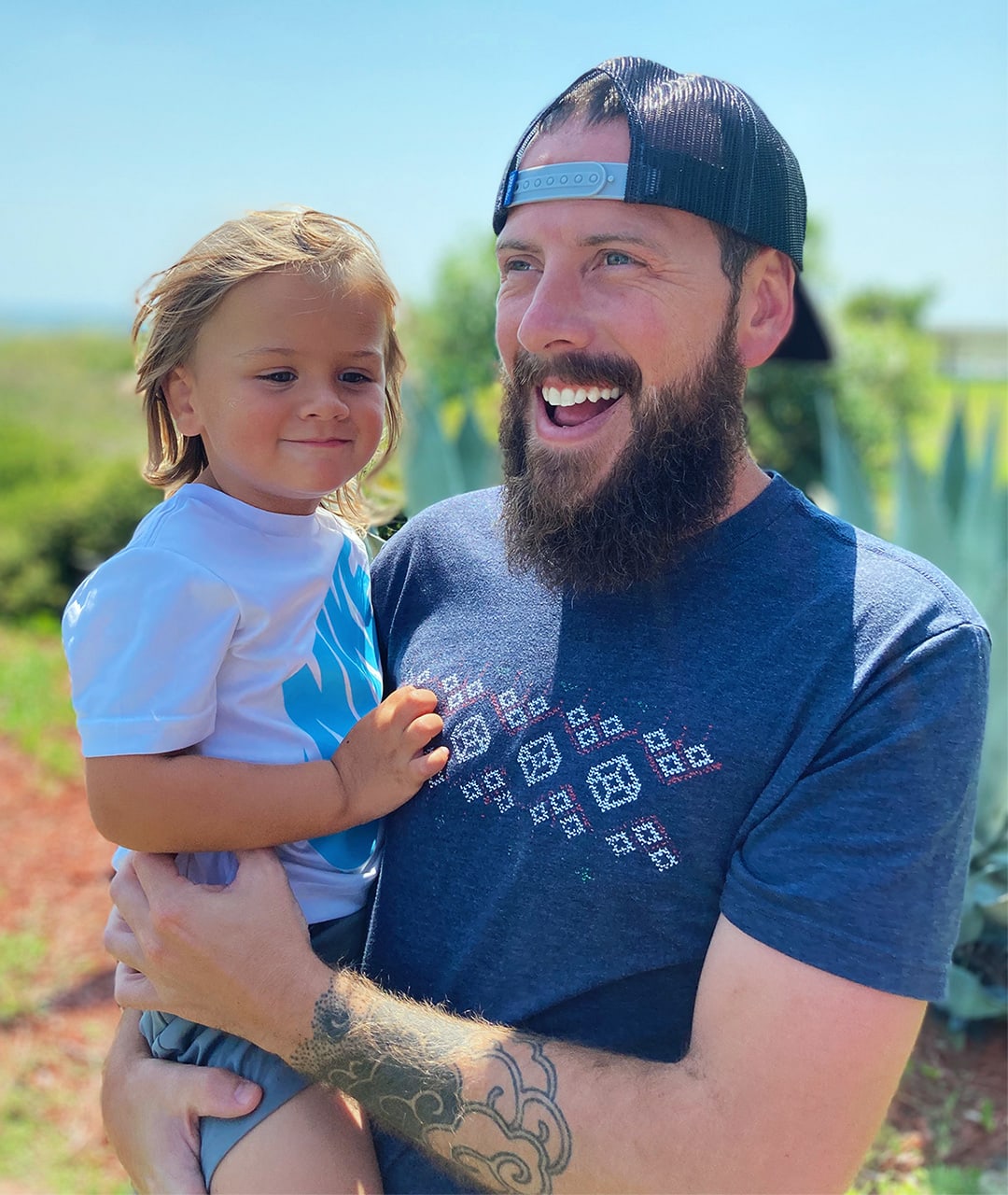 Robbie and his son smiling together