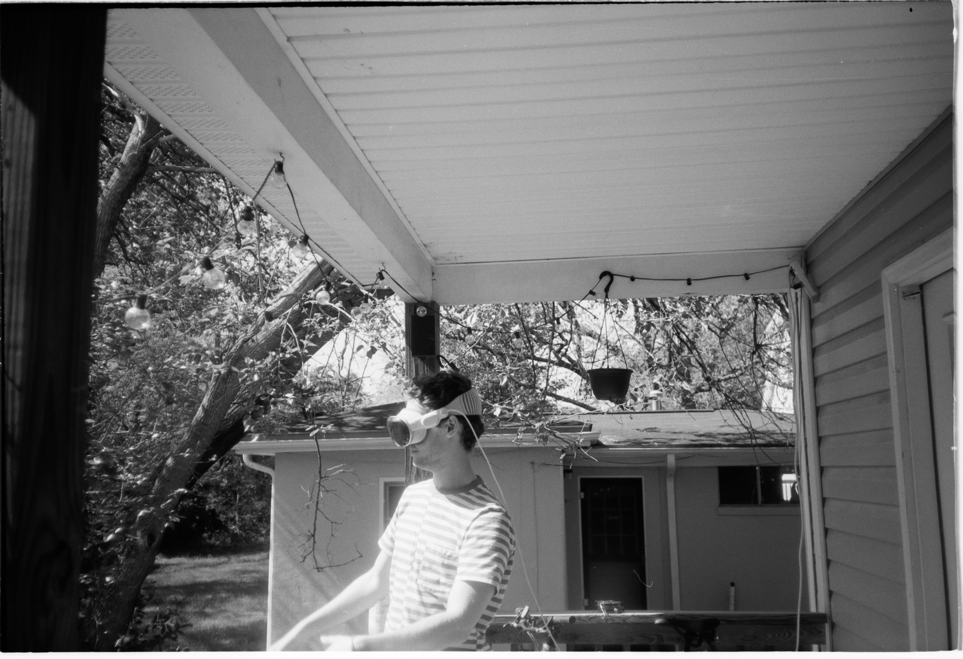 A friend wearing a VR headset on a back porch