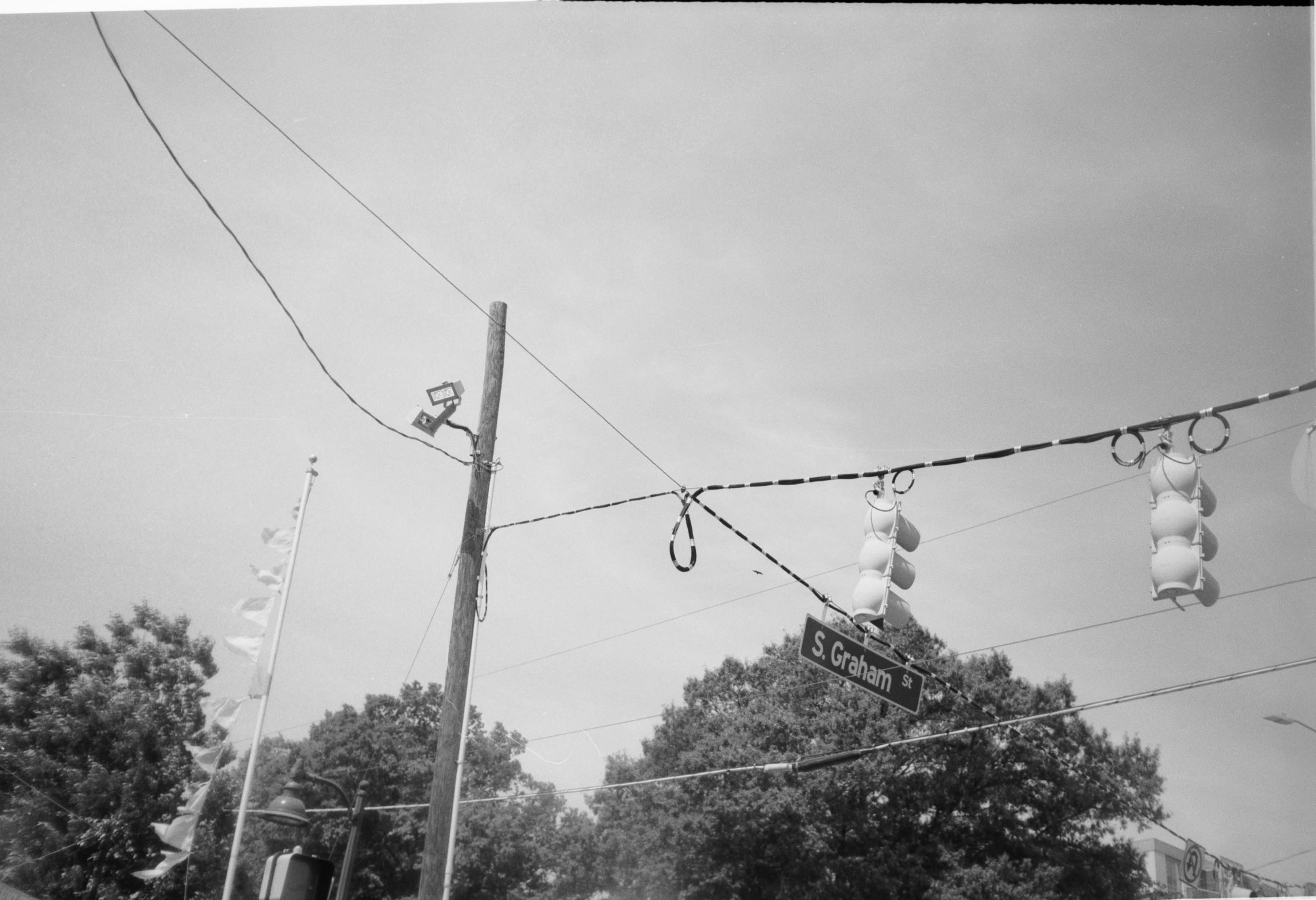 Traffic lights strung across an intersection beside a Graham St sign