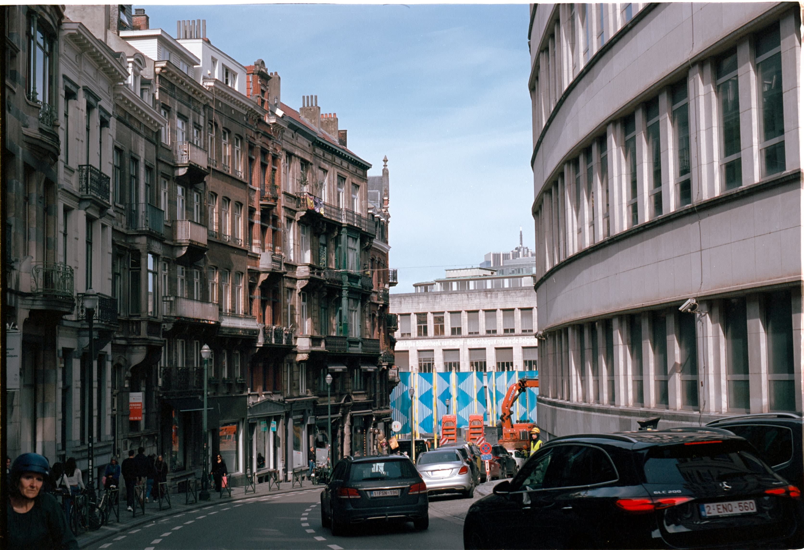 Traffic on a street of ornate townhouses