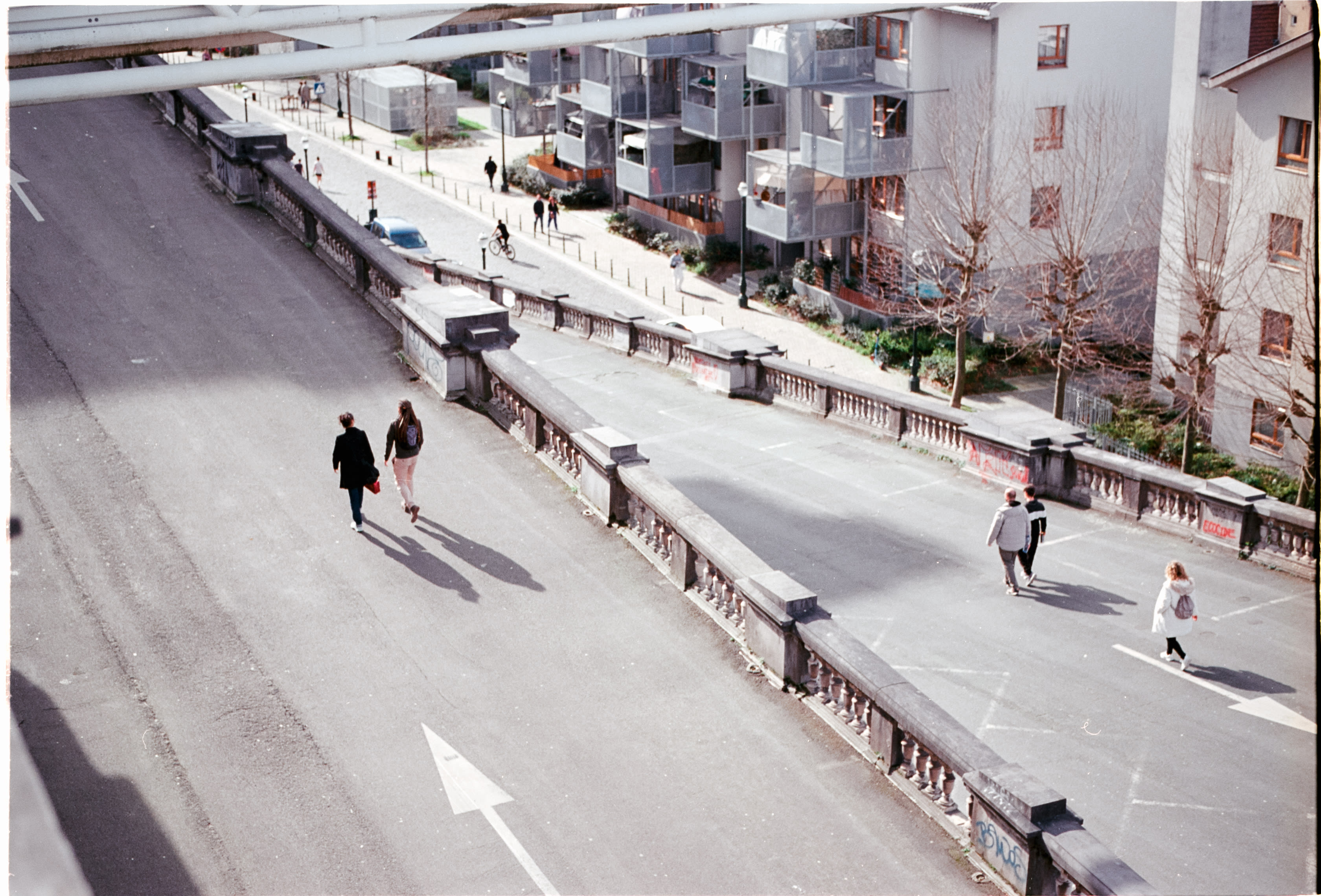 People walking along a wide pedestrian ramp, seen from above