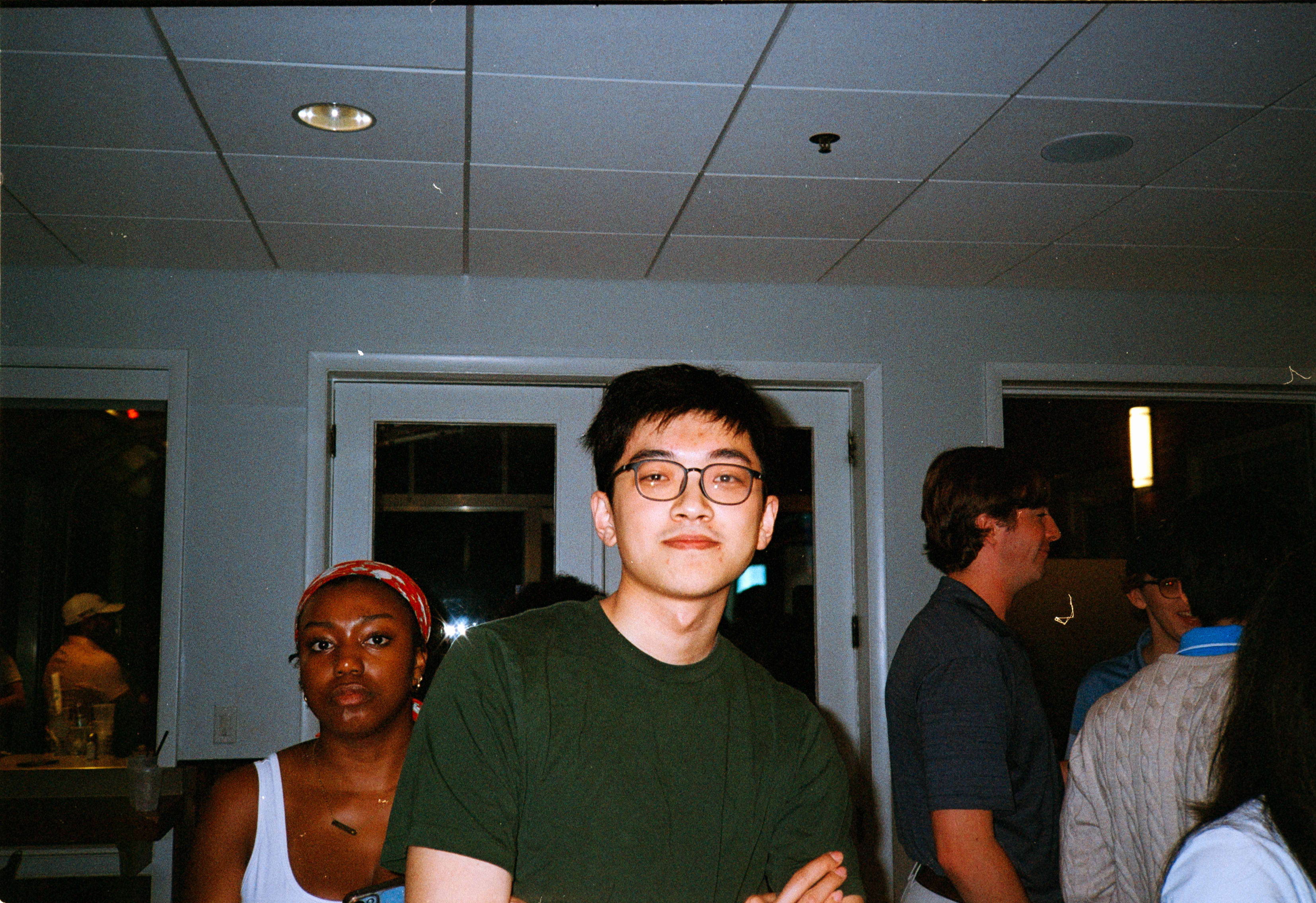 A friend in glasses and a green shirt at a party