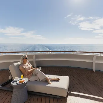 Guest relaxing on a private balcony overlooking the sea
