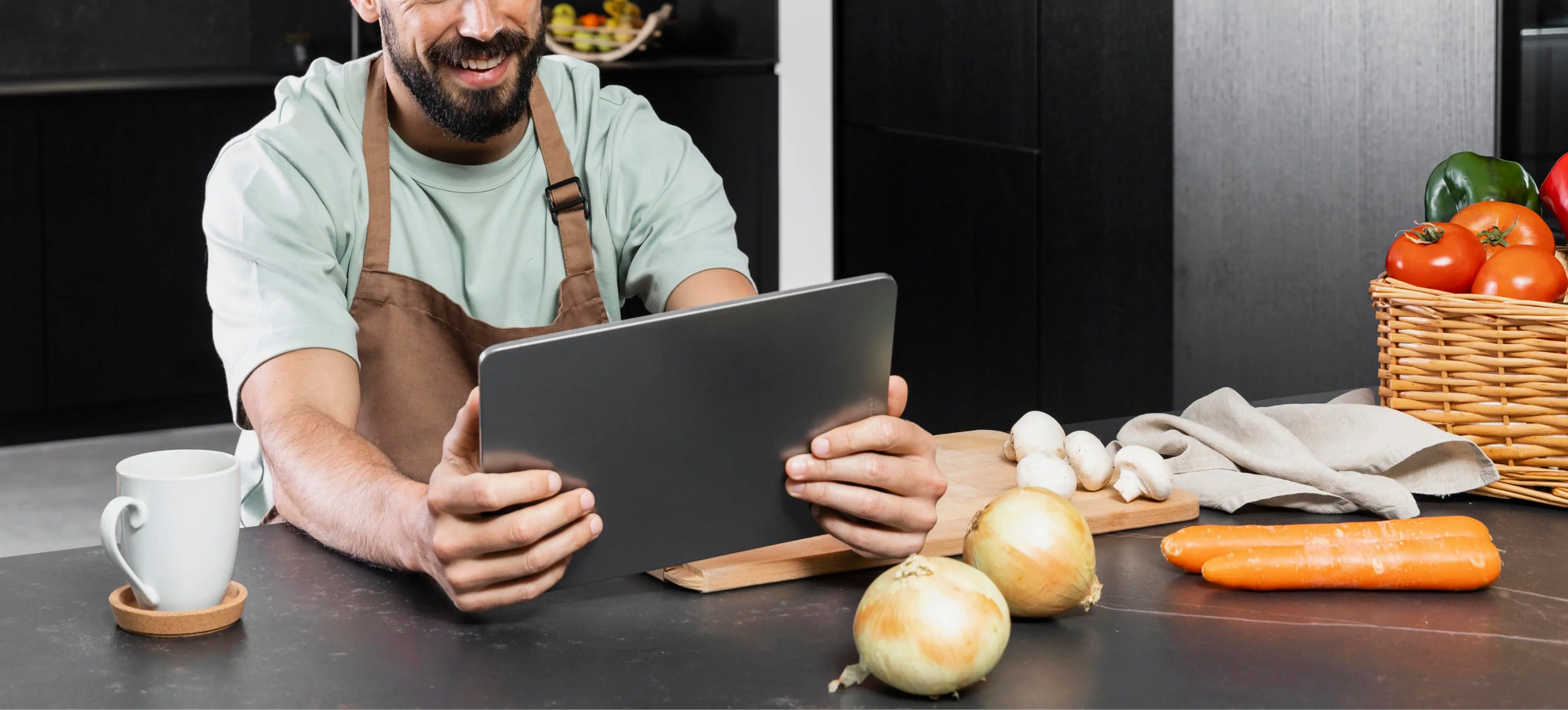 a man using a tablet on a kitchen