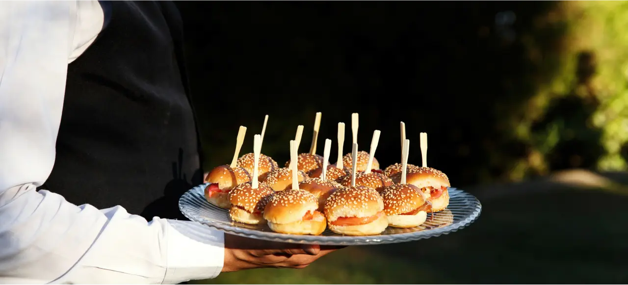 a waiter serving hamburgers 