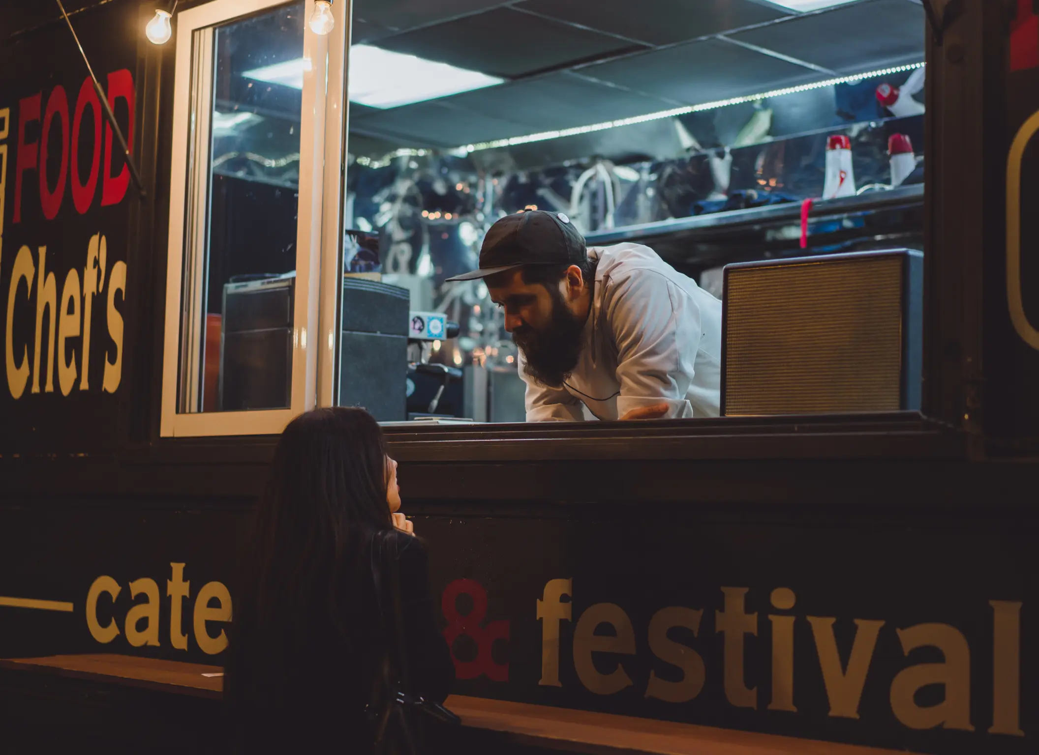 a man taking an order on a food truck