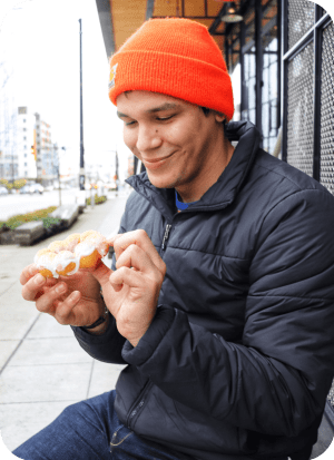 Joe happily eating a donut