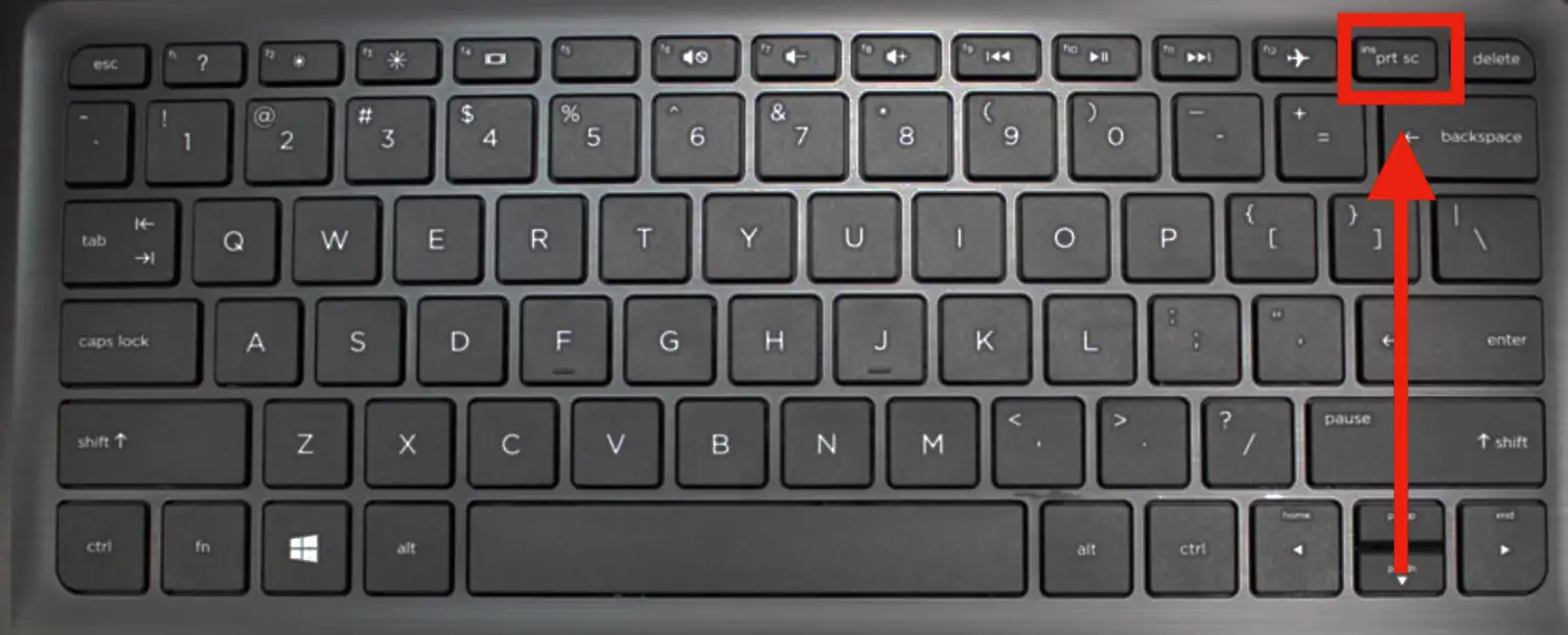 a picture of a laptop keyboard with a red arrow pointing to the printscreen button