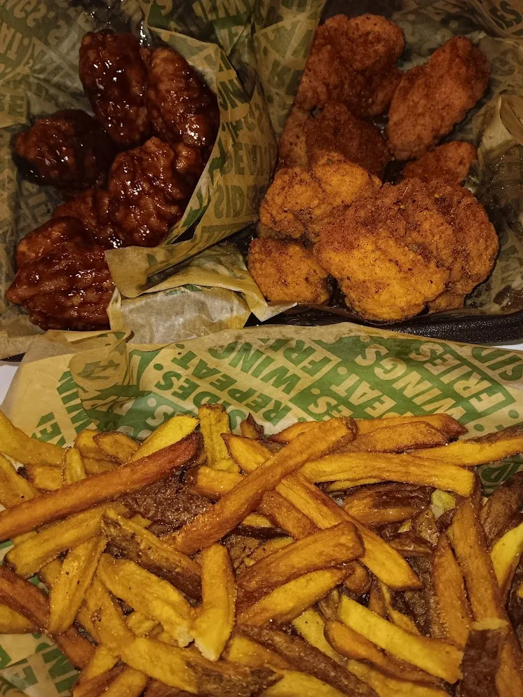 Wingstop food and storefront view at 4998 Highland Rd Suite B in Waterford Township, Michigan