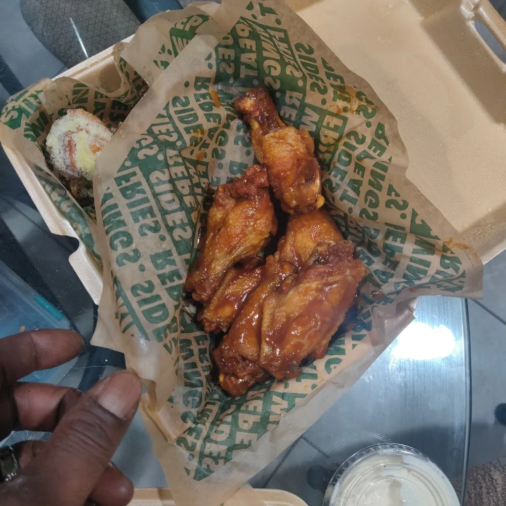Wingstop food and storefront view at 10841 W Florissant Ave in Ferguson, Missouri