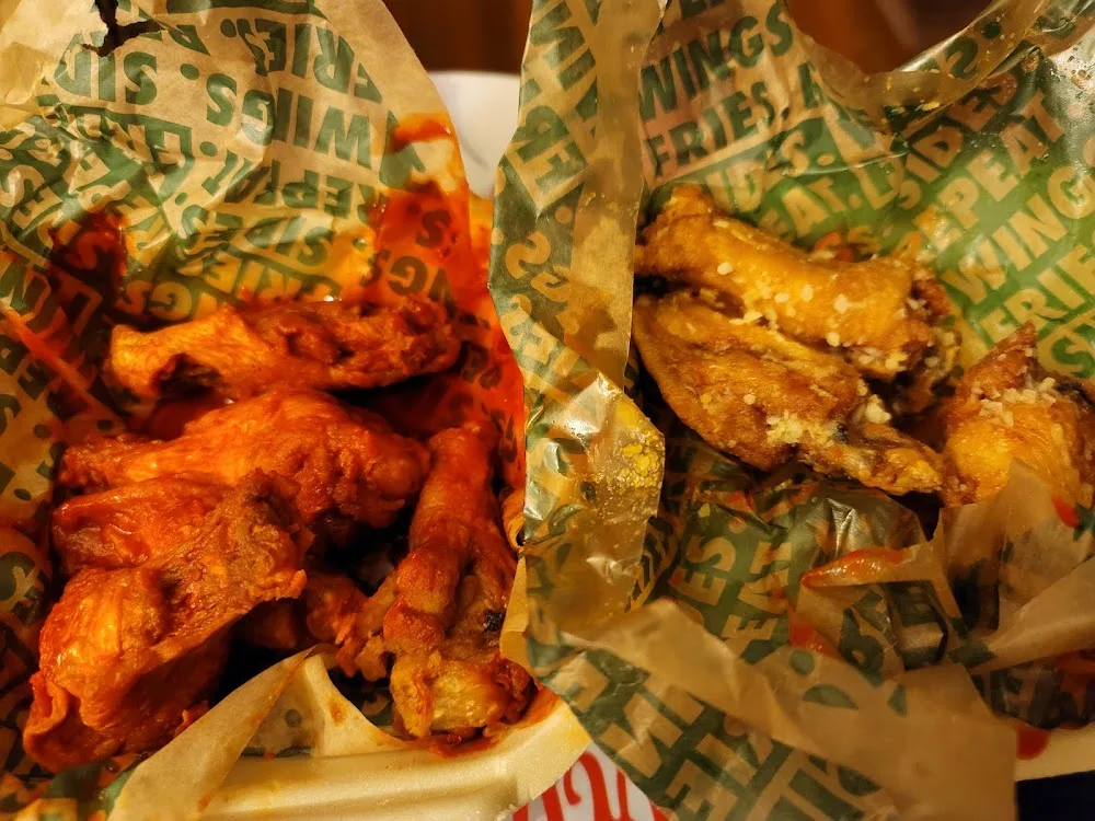 Wingstop food and storefront view at 116 3rd Avenue in Neptune City, New Jersey