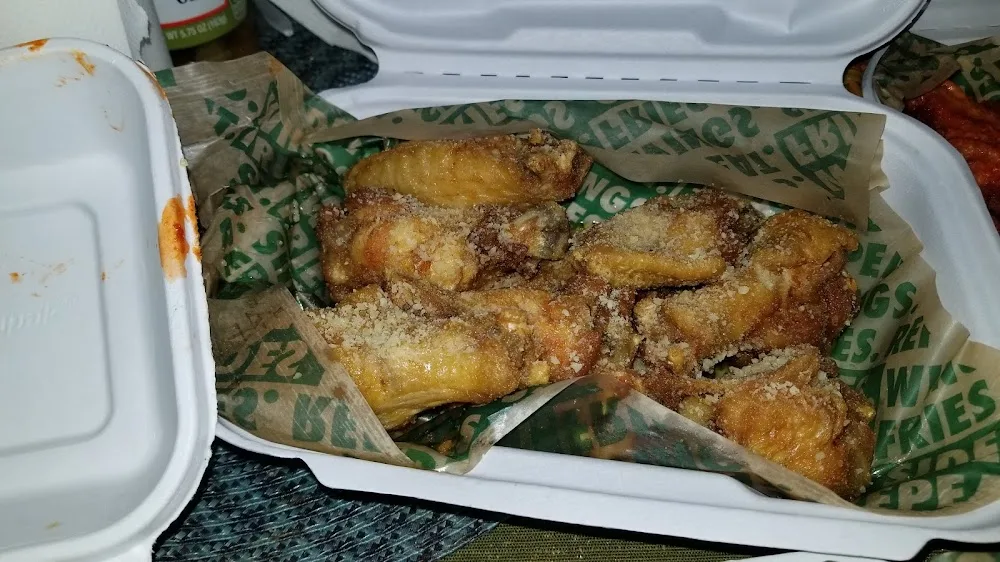 Wingstop food and storefront view at 12614 Merrick Blvd in Jamaica, New York