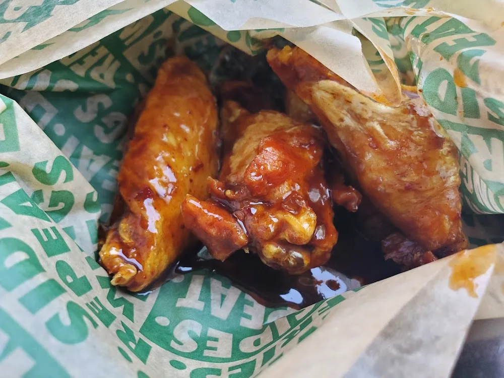Wingstop food and storefront view at 90 N. Genesee St. in Utica, New York