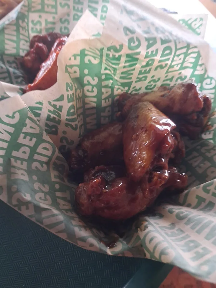 Wingstop food and storefront view at 173 Tovrea Road Suite G in Alvin, Texas
