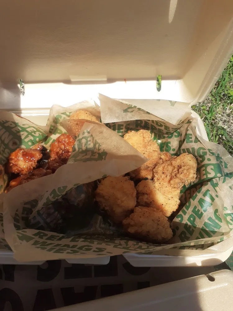 Wingstop food and storefront view at 1701 W Parmer Lane Suite 104 in Austin, Texas