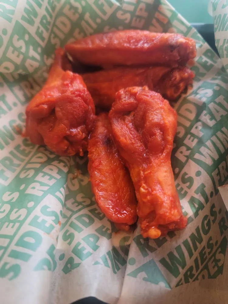 Wingstop food and storefront view at 1671 Main Street in Buda, Texas