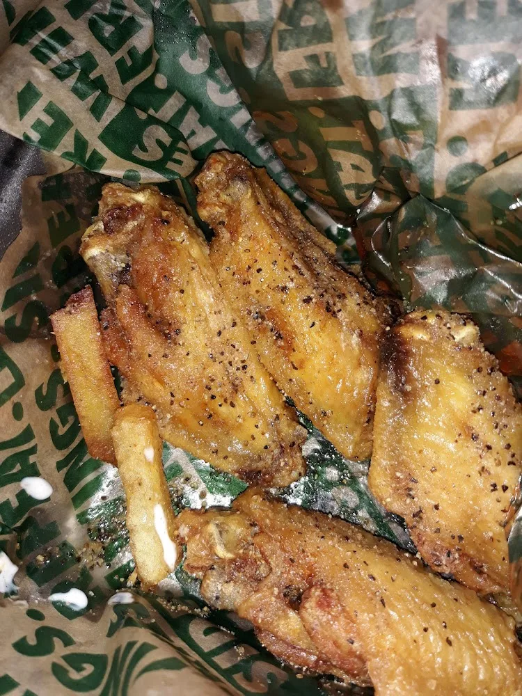 Wingstop food and storefront view at 3128 Forest Ln Ste 251 in Dallas, Texas