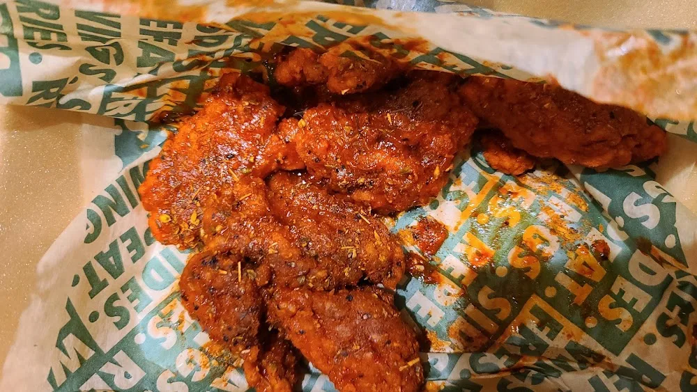 Wingstop food and storefront view at 2141 S International Pkwy in Dallas, Texas