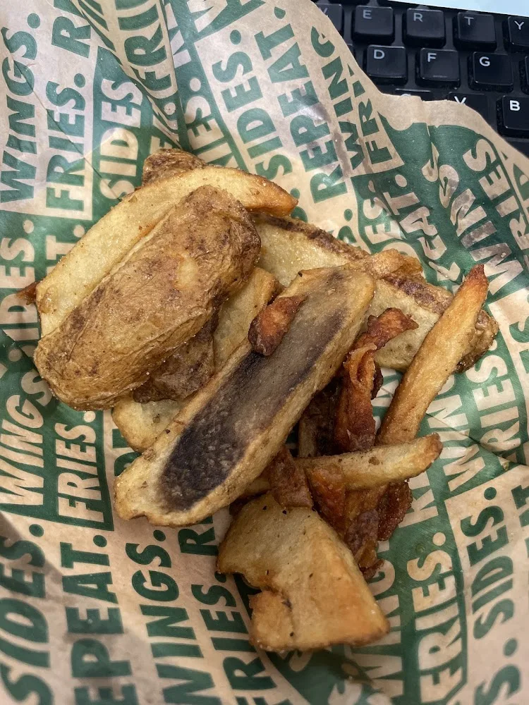 Wingstop food and storefront view at 9090 Skillman Street in Dallas, Texas