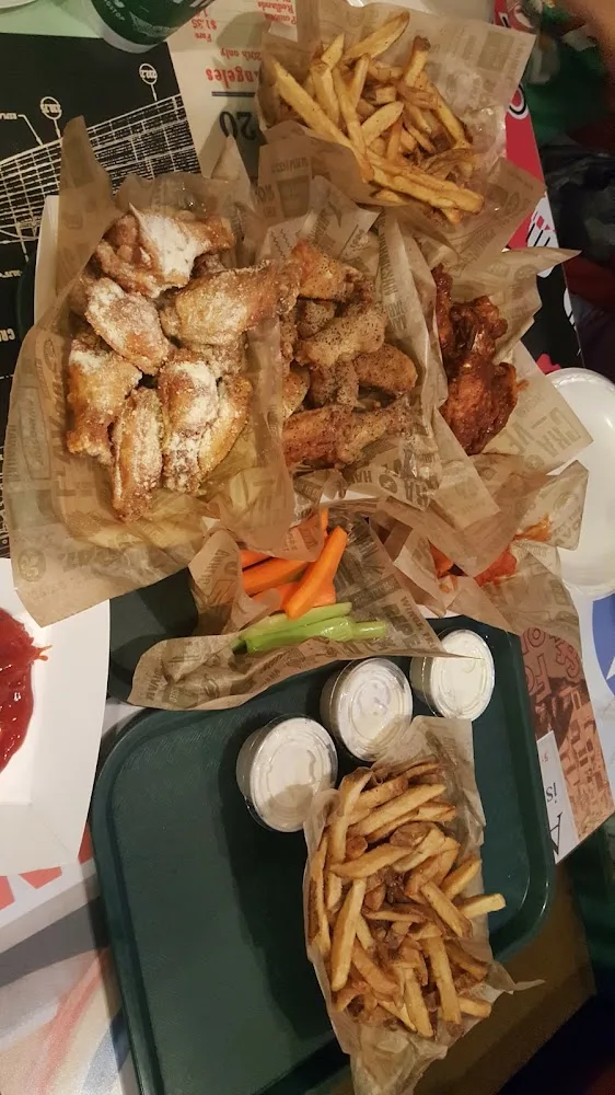 Wingstop food and storefront view at 7420 Mccart Ave Ste 108 in Fort Worth, Texas