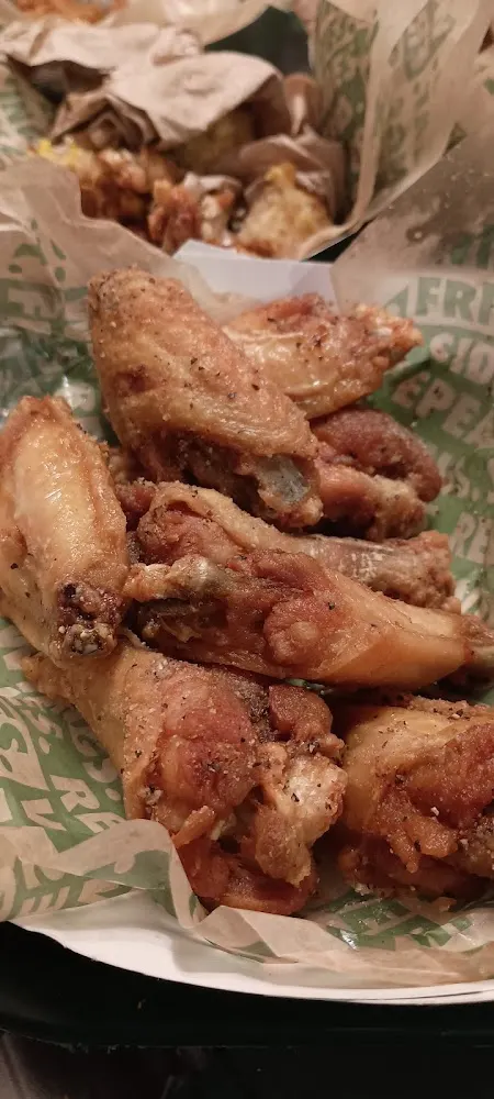 Wingstop food and storefront view at 8505 S. Sam Houston Pkwy E in Houston, Texas