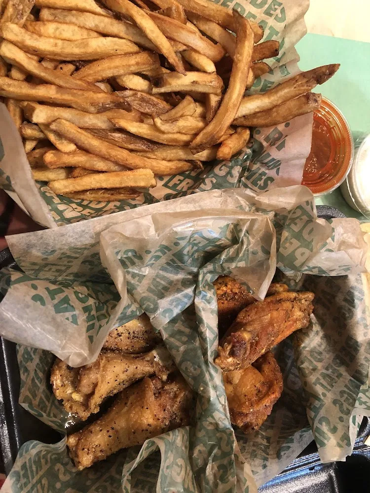 Wingstop food and storefront view at 11009 Fuqua St in Houston, Texas