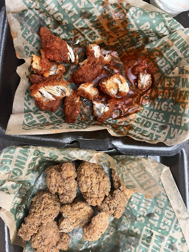 Wingstop food and storefront view at 12100 Veterans Memorial Dr Ste B in Houston, Texas