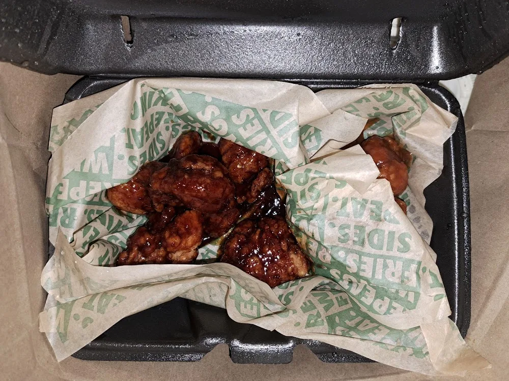 Wingstop food and storefront view at 12620 Woodforest Blvd Ste 470 in Houston, Texas