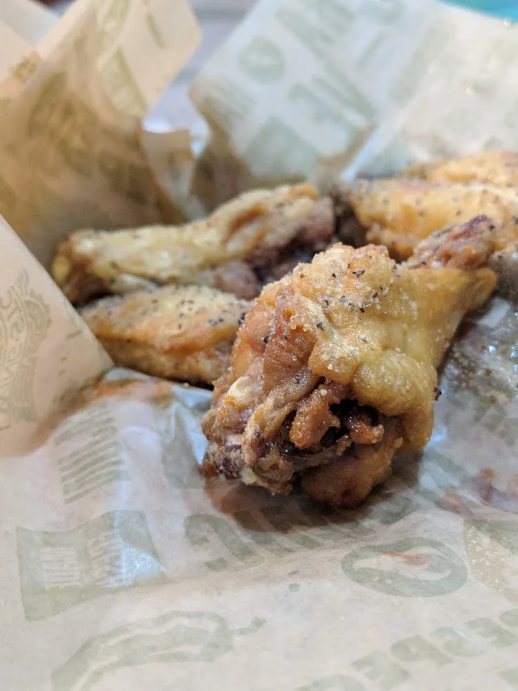 Wingstop food and storefront view at 712 Gulfgate Center Mall in Houston, Texas